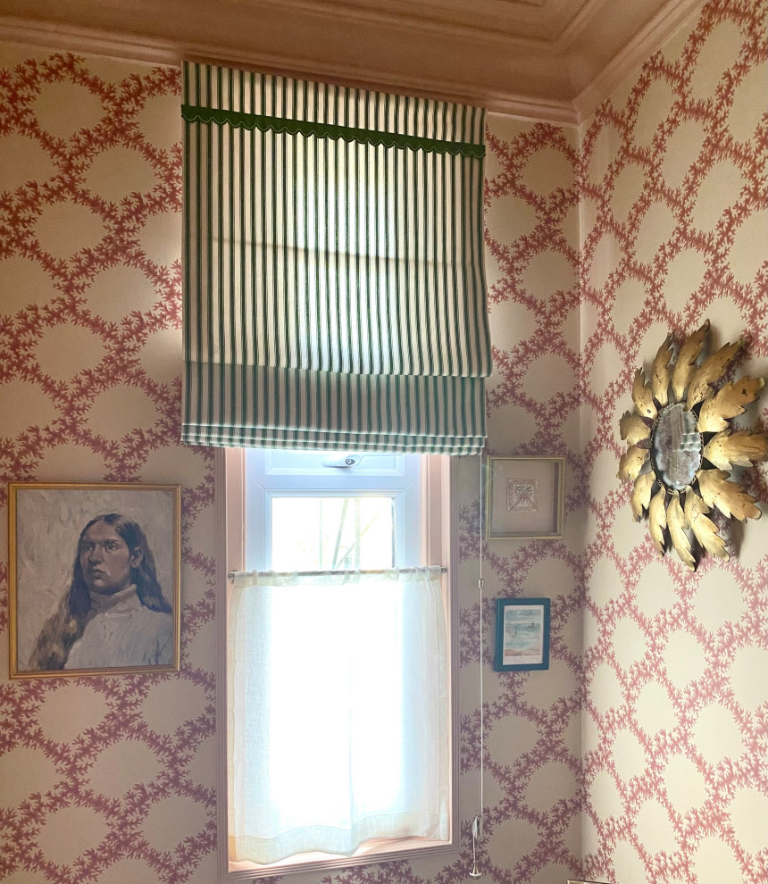 This is an example of a small traditional study in Kent with pink walls, carpet, no fireplace, a built-in desk, beige floors, a coffered ceiling and wallpapered walls.