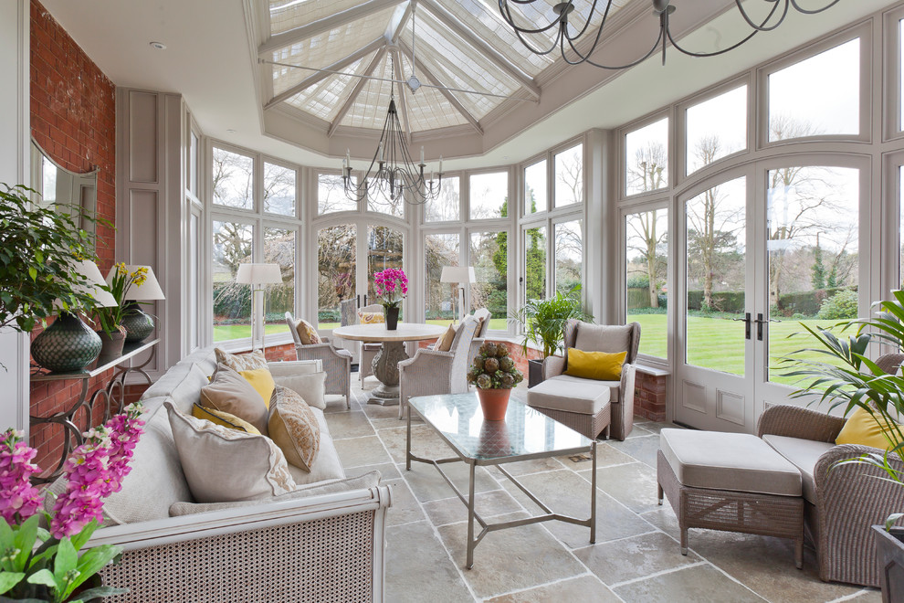 This is an example of a large traditional sunroom in Other with limestone floors, no fireplace and a glass ceiling.