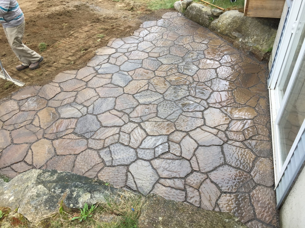 Photo of a small contemporary side yard patio in Burlington with concrete pavers.