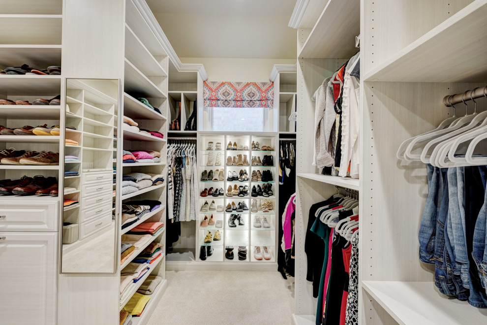 Design ideas for a large transitional gender-neutral dressing room in Oklahoma City with raised-panel cabinets, light wood cabinets, carpet and beige floor.