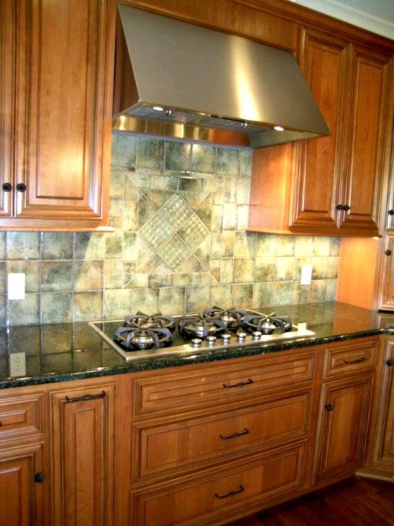 Kitchen - eclectic kitchen idea in Chicago with raised-panel cabinets, medium tone wood cabinets, granite countertops, ceramic backsplash and stainless steel appliances