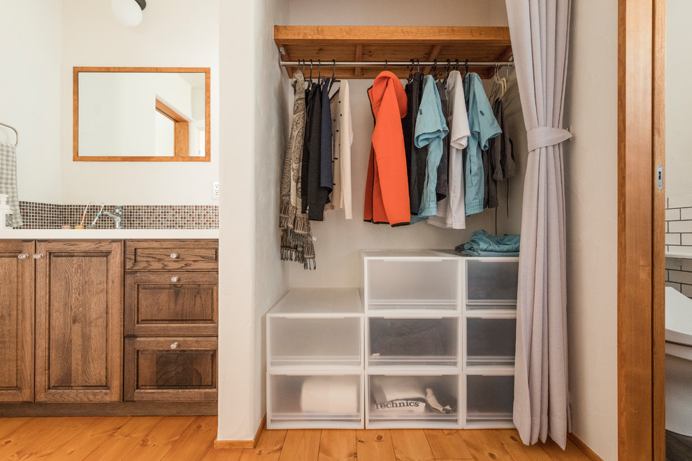 Eclectic wardrobe in Other with medium hardwood flooring and beige floors.