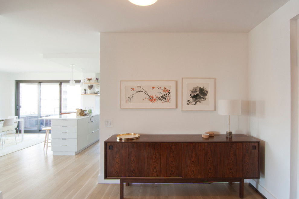 Inspiration for a small midcentury foyer in New York with white walls, light hardwood floors, a single front door, a metal front door and beige floor.