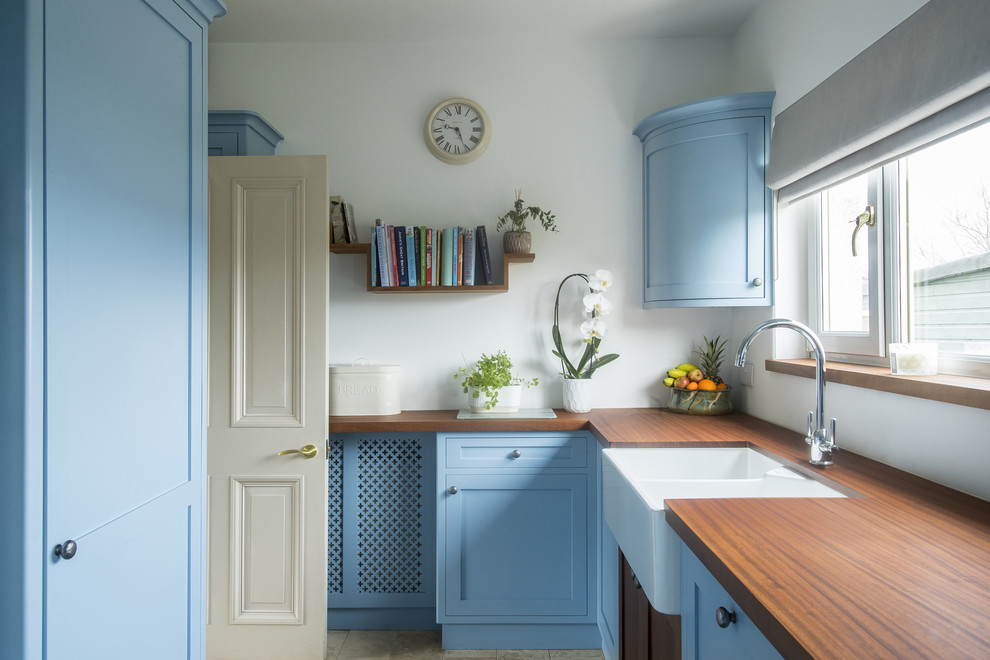 Inspiration for a traditional galley enclosed kitchen in Edinburgh with shaker cabinets, blue cabinets, wood worktops, white splashback and no island.