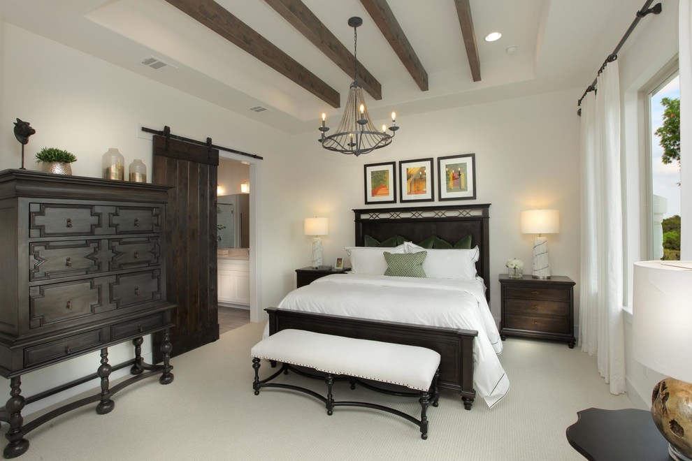 Photo of a mediterranean master bedroom in Austin with white walls, carpet and beige floor.