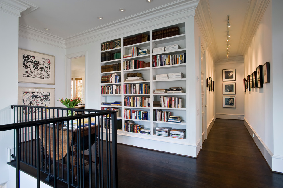 Traditional hallway in Houston with white walls and dark hardwood floors.