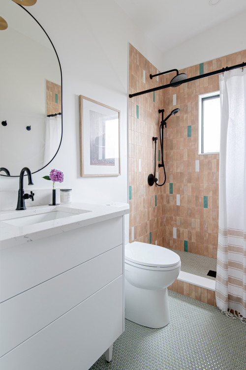 White Bathroom with Colorful Shower Tiles and Black Accents
