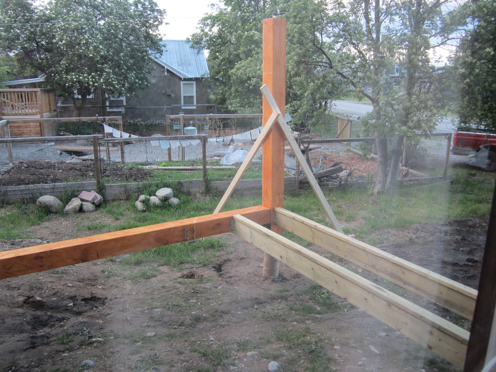 Inspiration for a mid-sized rustic side yard balcony deck remodel with a roof extension