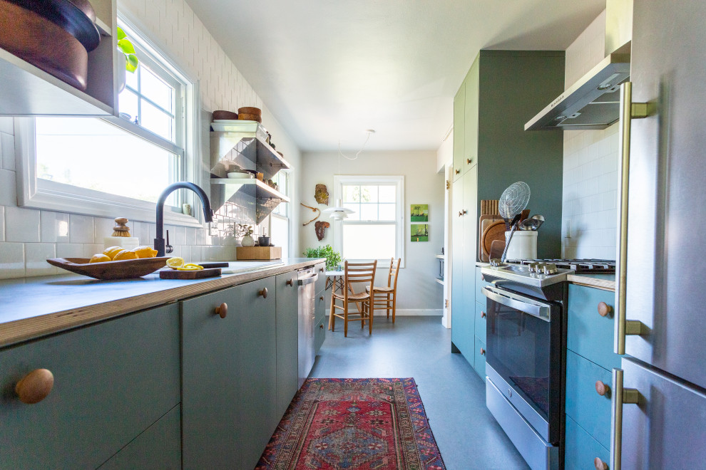 Design ideas for a mid-sized scandinavian galley separate kitchen in Portland with a drop-in sink, flat-panel cabinets, green cabinets, laminate benchtops, white splashback, ceramic splashback, stainless steel appliances, linoleum floors, no island, green floor and green benchtop.