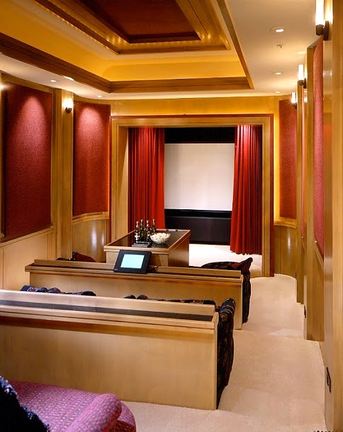 Inspiration for an expansive mediterranean enclosed home theatre in Phoenix with carpet, a projector screen and red walls.