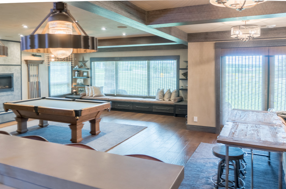 Basement - large rustic walk-out medium tone wood floor and brown floor basement idea in Calgary with gray walls and a stone fireplace