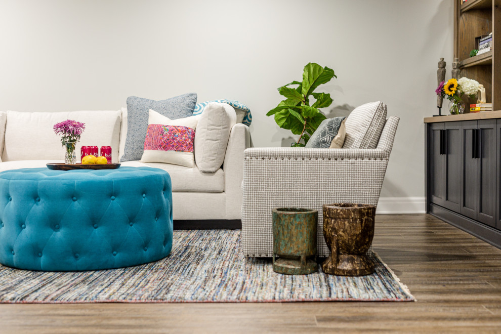 Inspiration for a large transitional underground laminate floor and brown floor basement remodel with gray walls and no fireplace
