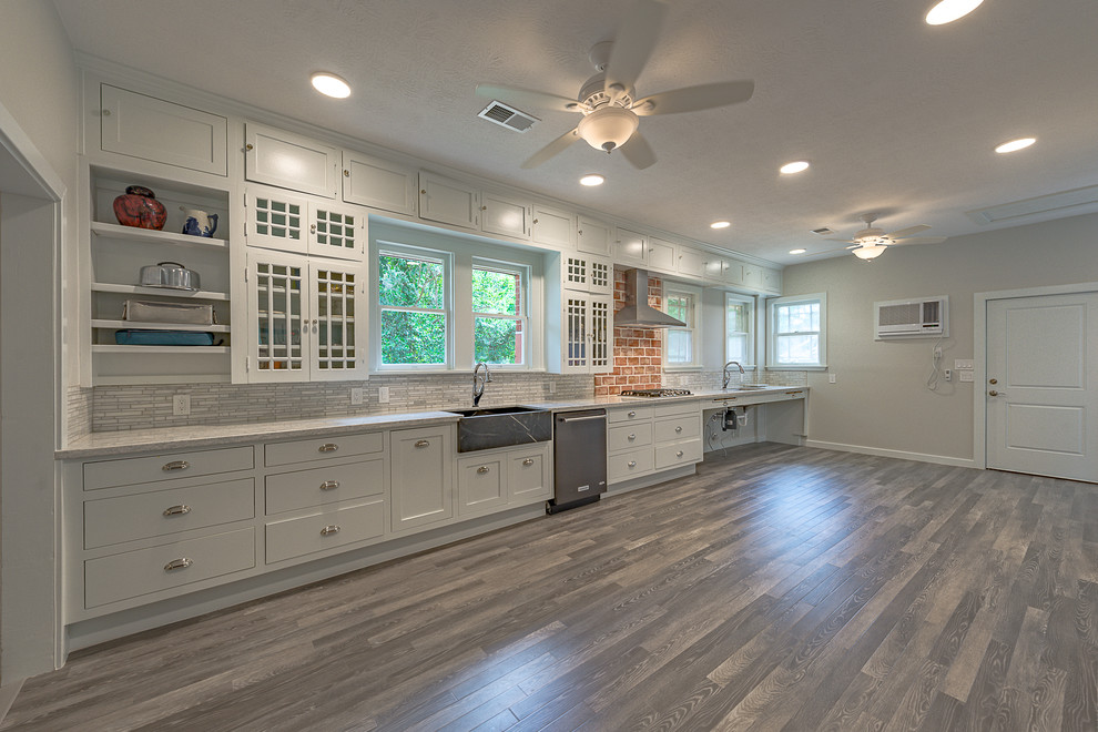 Example of a large mountain style galley dark wood floor eat-in kitchen design in Austin with a farmhouse sink, open cabinets, white cabinets, quartzite countertops, multicolored backsplash, marble backsplash, stainless steel appliances and no island