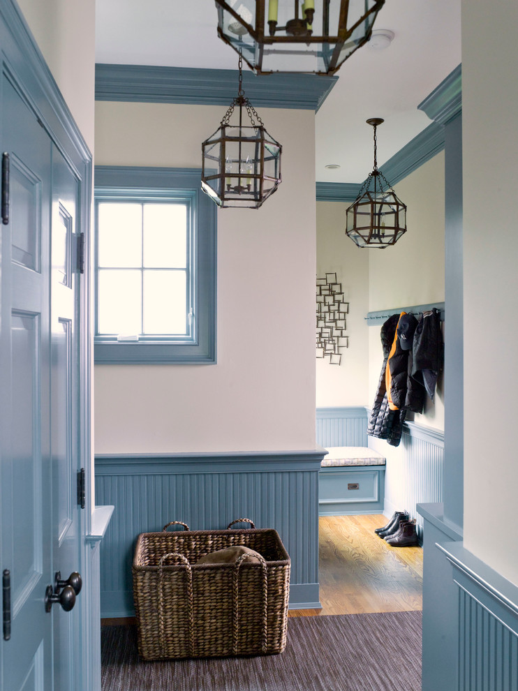 Mid-sized traditional hallway in Dallas with blue walls, medium hardwood floors and brown floor.