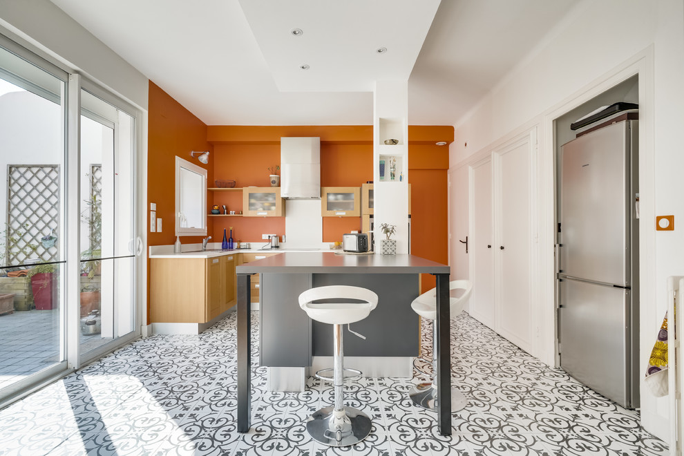 Large mediterranean l-shaped kitchen in Other with multi-coloured floor, light wood cabinets, white splashback, stainless steel appliances, with island and white benchtop.