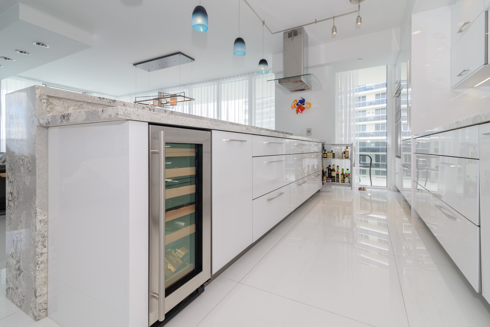 Mid-sized modern galley separate kitchen in Miami with a single-bowl sink, flat-panel cabinets, white cabinets, quartz benchtops, metallic splashback, metal splashback, panelled appliances, porcelain floors, no island and white floor.
