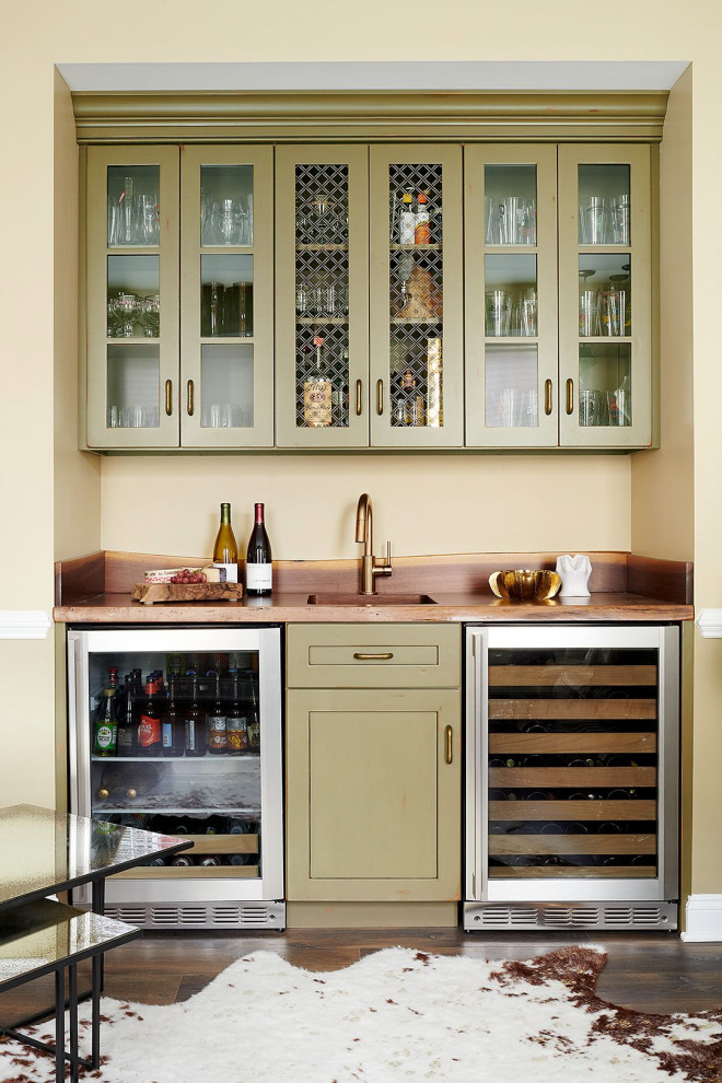 Photo of a mid-sized eclectic galley wet bar in Philadelphia with an undermount sink, shaker cabinets, green cabinets, wood benchtops, timber splashback, dark hardwood floors, brown floor and brown benchtop.