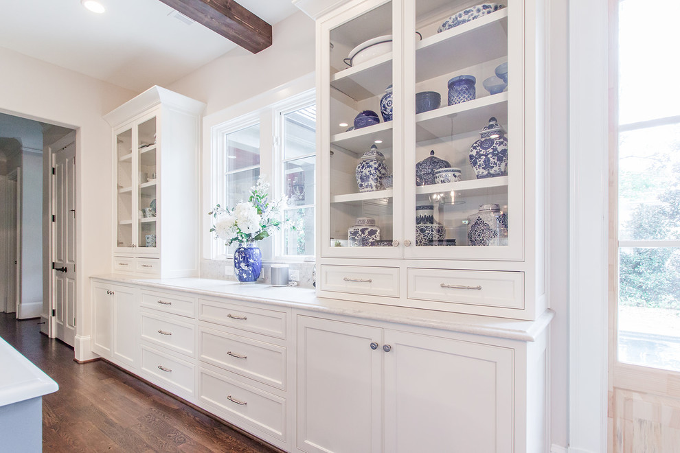 Beach style kitchen in Atlanta with flat-panel cabinets, white cabinets, with island and white benchtop.