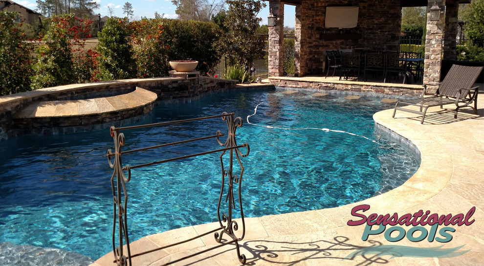 Example of a large tuscan backyard concrete and custom-shaped natural pool fountain design