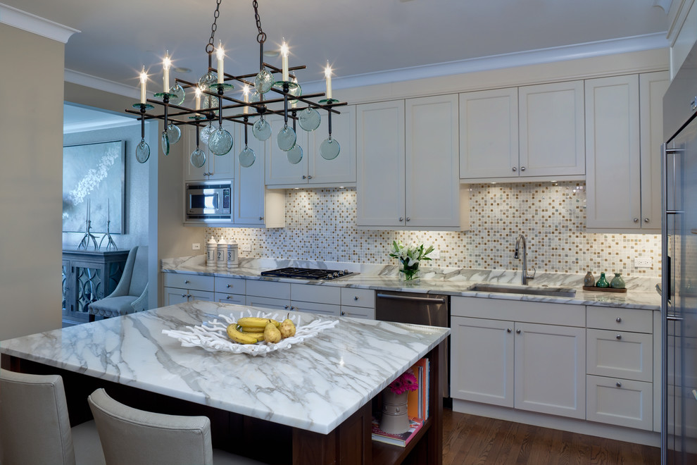 Design ideas for a traditional kitchen in Chicago with an undermount sink, shaker cabinets, white cabinets, multi-coloured splashback and stainless steel appliances.