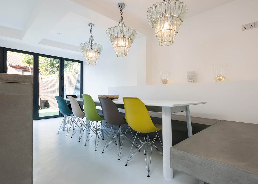 Design ideas for a large contemporary open plan dining in London with concrete floors and white walls.