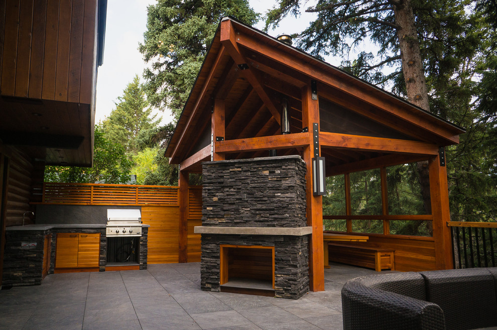 Mountain style backyard deck photo in Calgary
