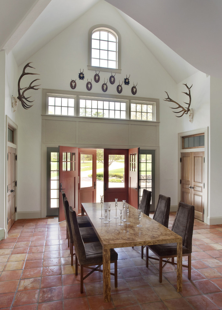 Inspiration for a country dining room in Boston with white walls, terra-cotta floors and pink floor.