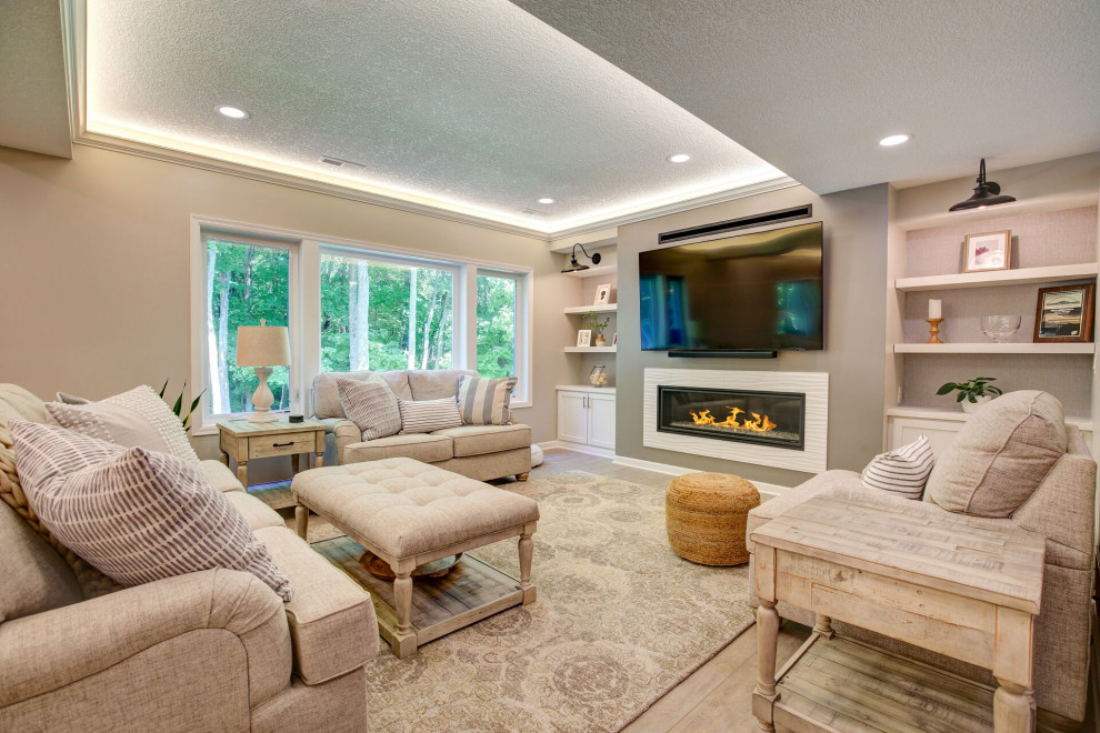 Large contemporary walk-out basement in Minneapolis with a home bar, grey walls, vinyl flooring, a standard fireplace, a tiled fireplace surround, grey floors, a drop ceiling and wallpapered walls.