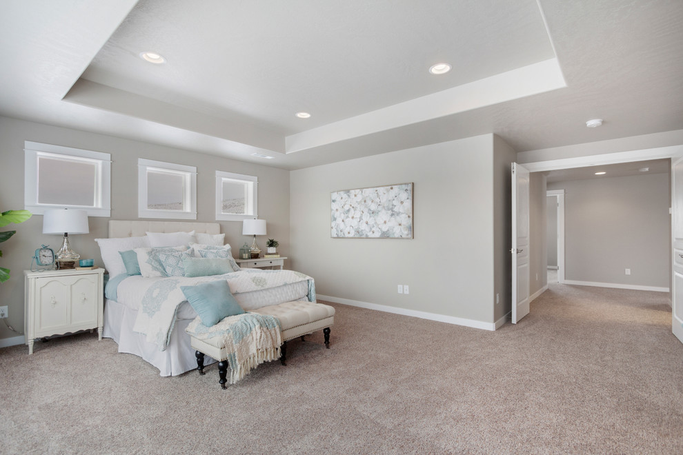 This is an example of a large traditional master bedroom in Other with grey walls, carpet and beige floor.