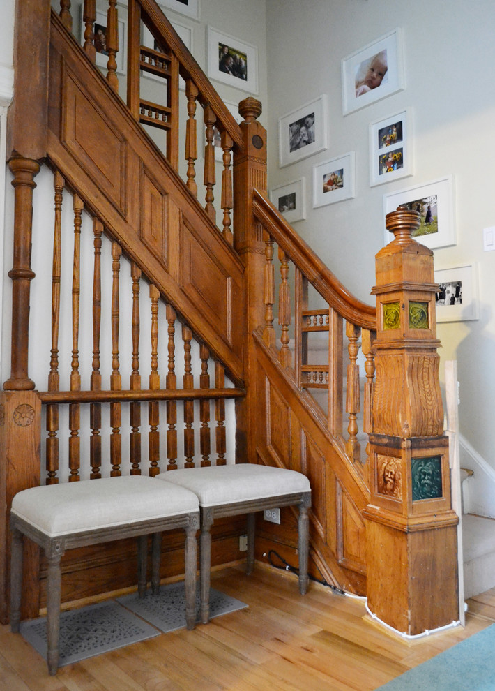 Photo of an eclectic staircase in New York with wood railing.