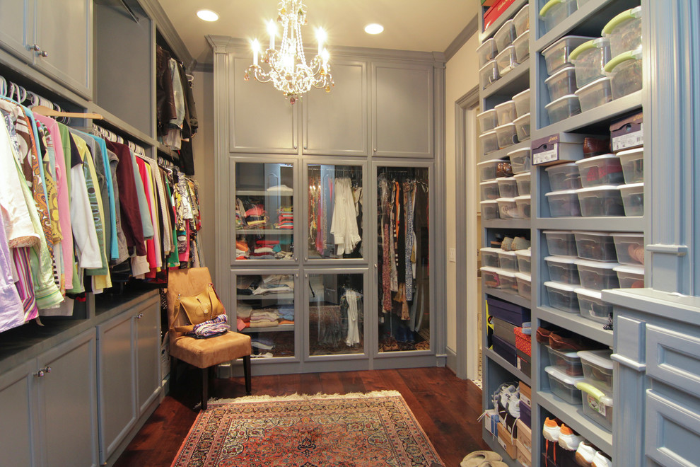 Large traditional gender-neutral walk-in wardrobe in Houston with shaker cabinets, grey cabinets and dark hardwood floors.