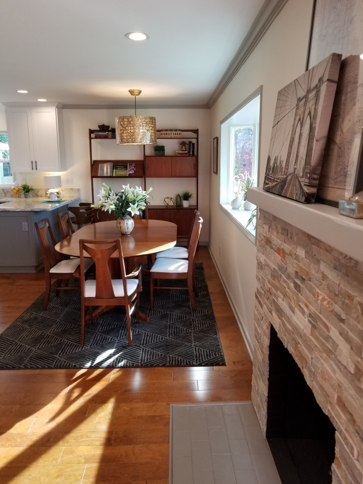 Retro Wohnküche mit beiger Wandfarbe, braunem Holzboden, Kamin, Kaminumrandung aus gestapelten Steinen und braunem Boden in Los Angeles