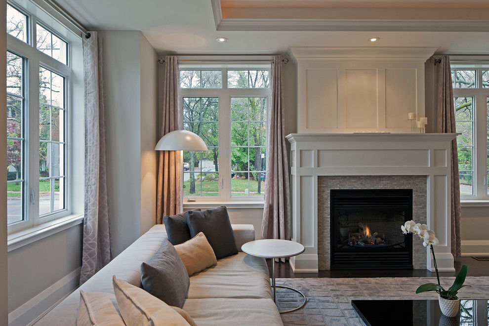 This is an example of a transitional living room in Toronto with a tile fireplace surround.