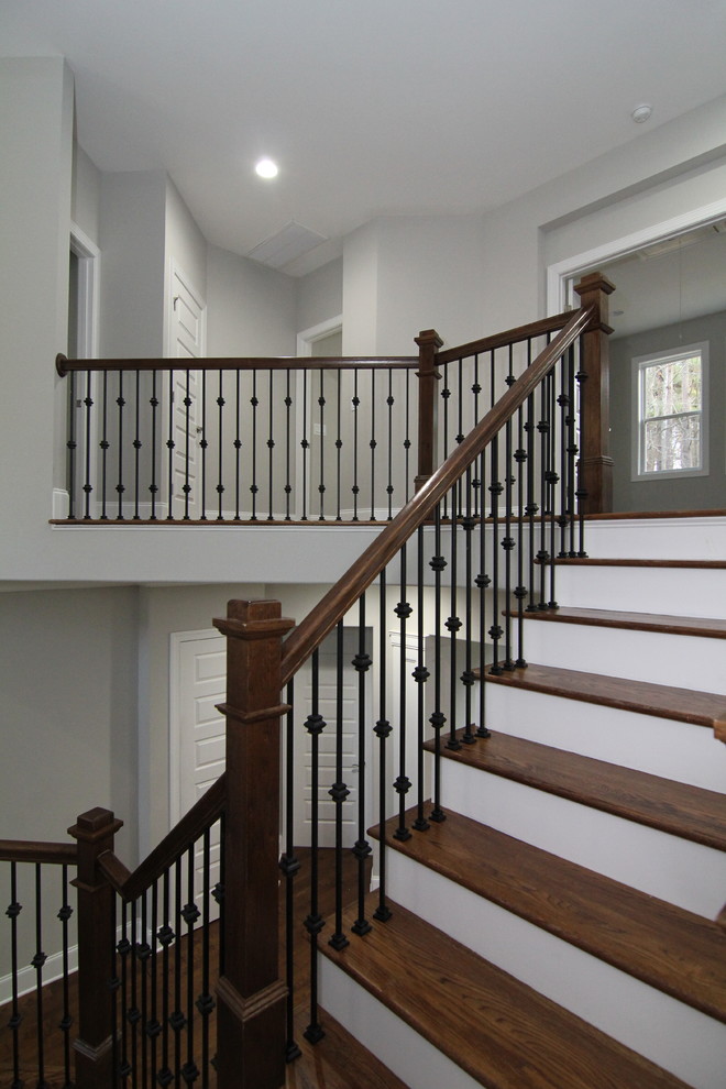 Large trendy wooden l-shaped staircase photo in Raleigh with painted risers
