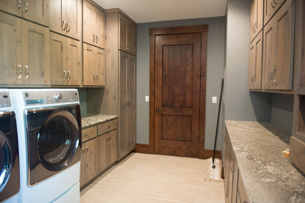 Huge mountain style u-shaped gray floor utility room photo with an undermount sink, flat-panel cabinets, light wood cabinets, granite countertops, blue walls, a side-by-side washer/dryer and multicolored countertops