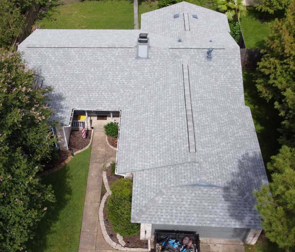 This is an example of a medium sized and gey classic bungalow detached house in Houston with concrete fibreboard cladding, a pitched roof, a shingle roof, a grey roof and shiplap cladding.