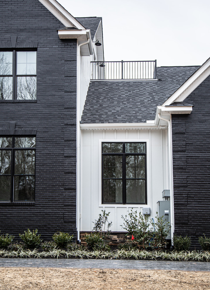 Inspiration for a large country multi-coloured house exterior in DC Metro with four or more storeys, mixed siding, a gable roof, a mixed roof, a black roof and board and batten siding.