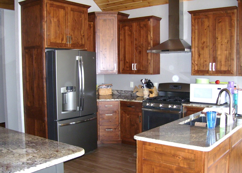 Mid-sized mountain style u-shaped eat-in kitchen photo in Cedar Rapids with flat-panel cabinets, medium tone wood cabinets and an island