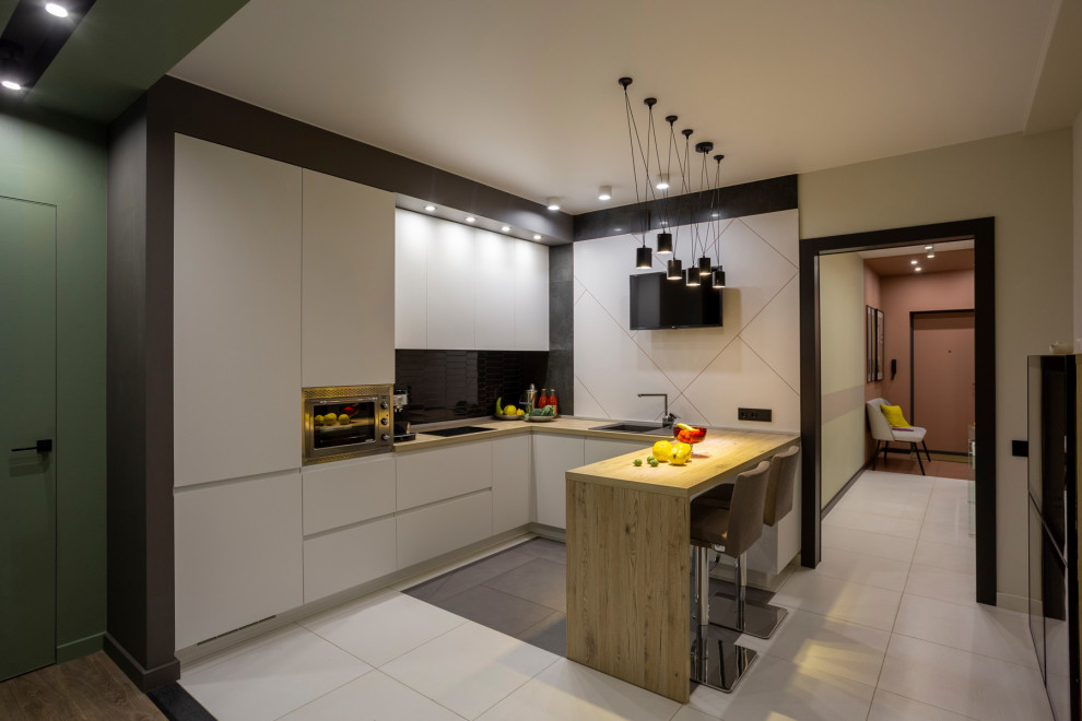 Mid-sized trendy u-shaped porcelain tile and white floor eat-in kitchen photo in Yekaterinburg with a drop-in sink, flat-panel cabinets, white cabinets, laminate countertops, porcelain backsplash, stainless steel appliances, a peninsula and brown countertops