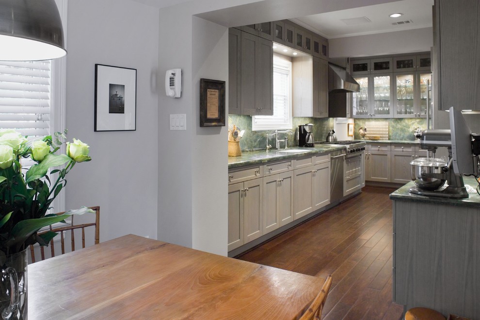Design ideas for a large eclectic galley eat-in kitchen in Houston with an undermount sink, shaker cabinets, grey cabinets, granite benchtops, green splashback, stainless steel appliances, stone slab splashback and dark hardwood floors.