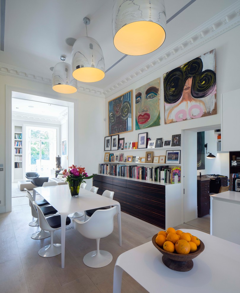 Design ideas for a mid-sized eclectic dining room in London with white walls and beige floor.