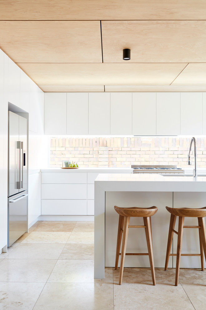 This is an example of a scandinavian l-shaped kitchen in Brisbane with an undermount sink, flat-panel cabinets, white cabinets, stainless steel appliances and with island.