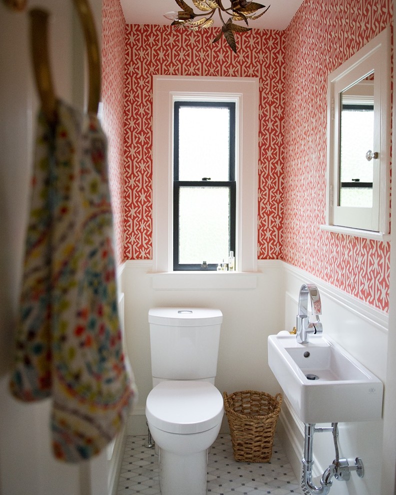 This is an example of a small eclectic powder room in Other with marble floors, a wall-mount sink, a one-piece toilet, multi-coloured walls and solid surface benchtops.