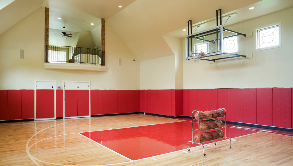 Expansive modern home gym in Kansas City with beige walls and light hardwood floors.