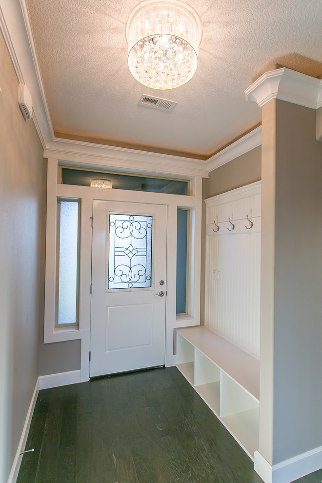 Example of a small transitional dark wood floor front door design in Seattle with gray walls and a white front door