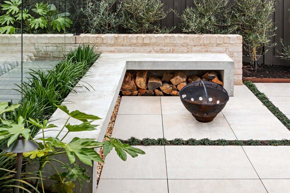Design ideas for a mid-sized contemporary backyard patio in Melbourne with a fire feature and concrete pavers.