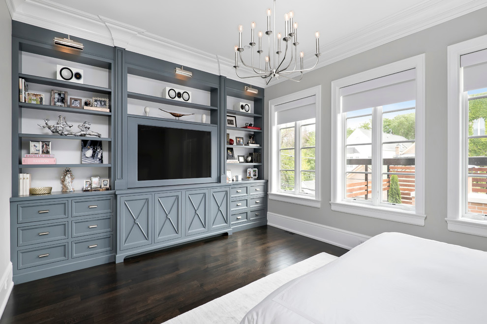This is an example of a large transitional master bedroom in Chicago with grey walls and dark hardwood floors.