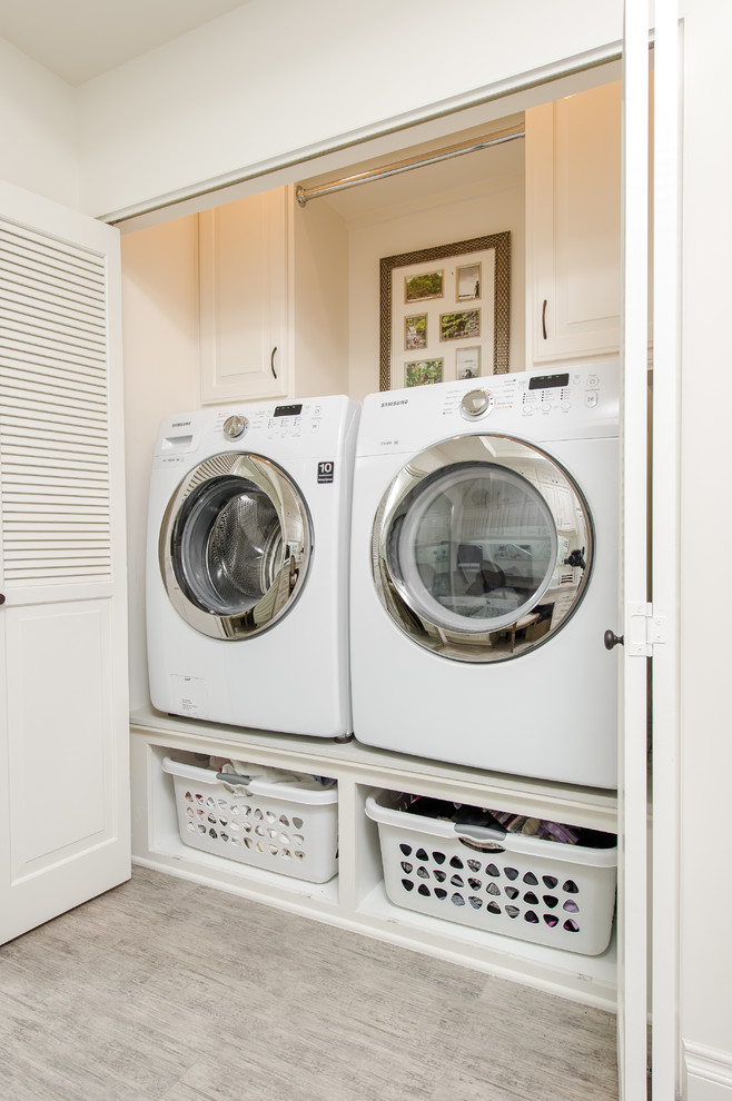 Inspiration for a small timeless single-wall porcelain tile laundry closet remodel in Los Angeles with raised-panel cabinets, white cabinets, quartz countertops, white walls and a side-by-side washer/dryer