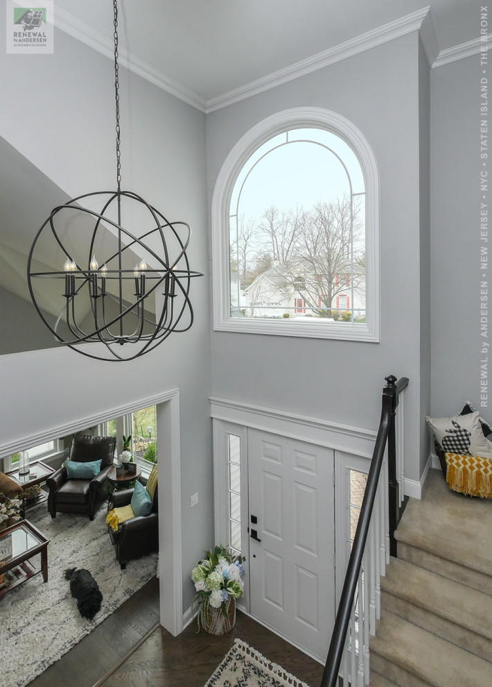 Design ideas for a mid-sized foyer in Newark with grey walls, dark hardwood floors, a single front door, a white front door, multi-coloured floor and vaulted.