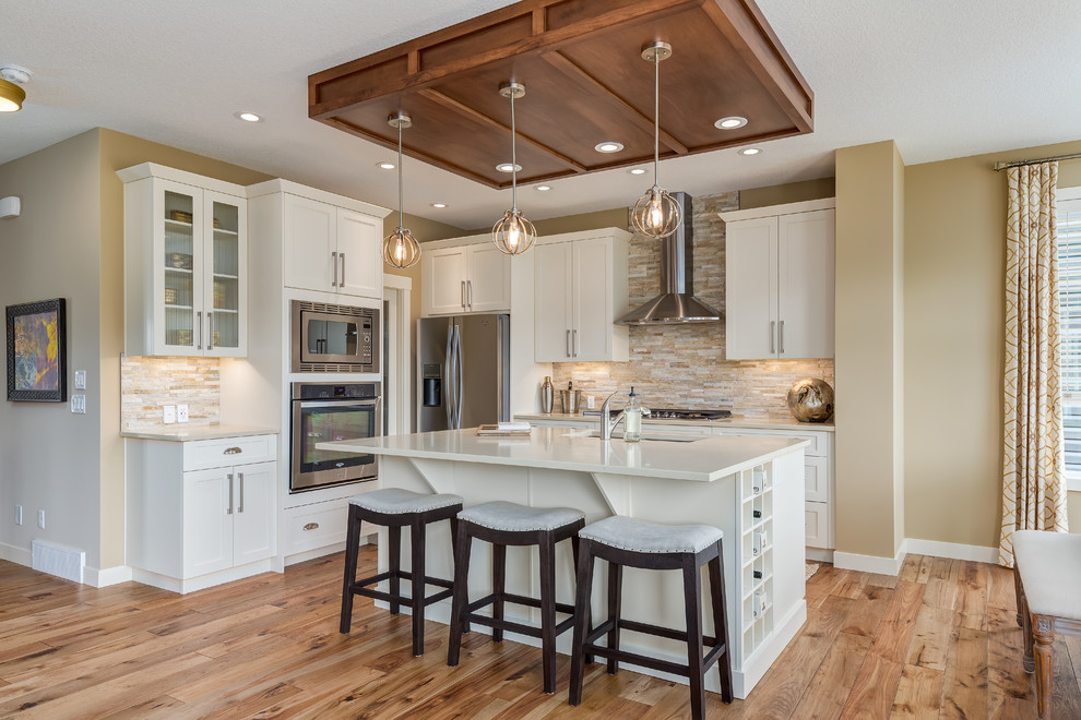 Example of a transitional kitchen design in Calgary